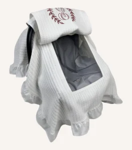 Beyaz örgü pike kumaşlı, kenarları fırfırlı, kapak kısmı düz, kişiselleştirilebilir puset örtüsü.