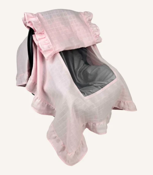 Pembe tek kat müslin kumaştan, fırfırlı kapak ve kenarlara sahip puset örtüsü.