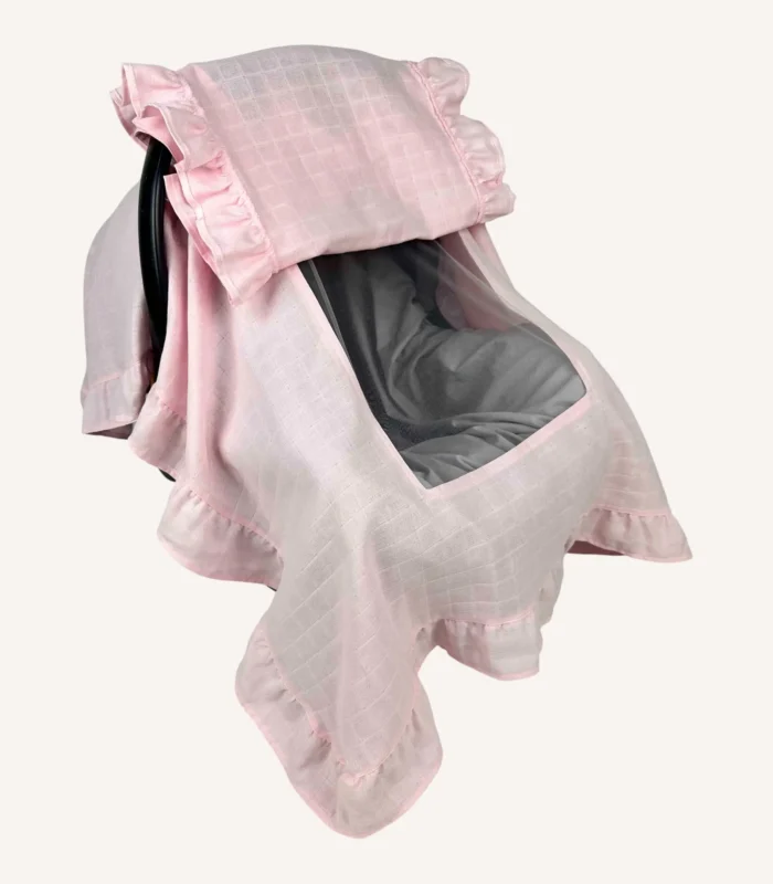 Pembe tek kat müslin kumaştan, fırfırlı kapak ve kenarlara sahip puset örtüsü.