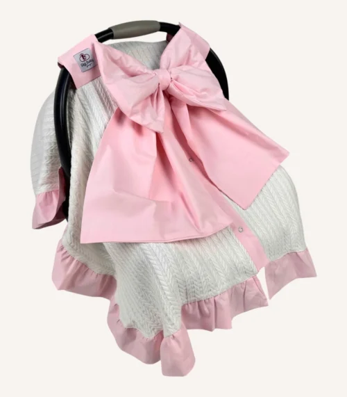 Krem örgü pike puset örtüsü, pembe fiyonklu, ortadan yırtmaçlı çıtçıtlı model, fırfırlı kenarlı, %100 pamuk bebek puset örtüsü